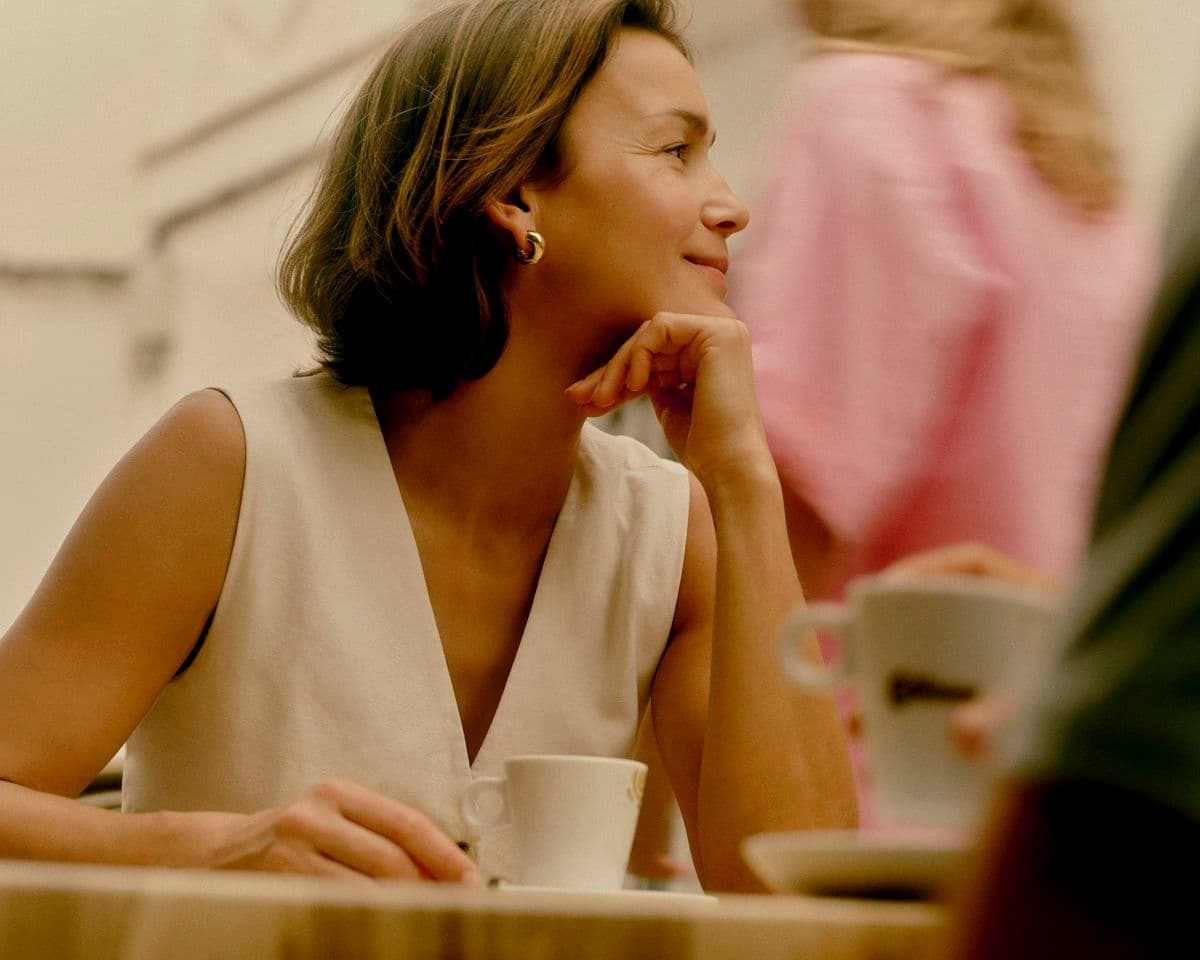 A woman in tech, mid-conversation, lit by soft window light.